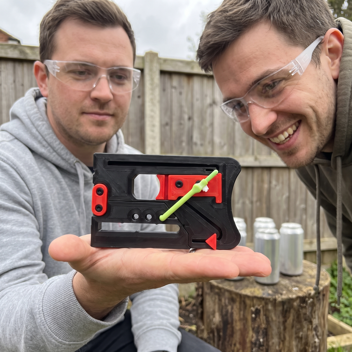 Two friends with a black Sling Pop card slingshot